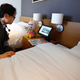 A hotel staffer talks with the concierge robot “Chu-ri-Robo.”